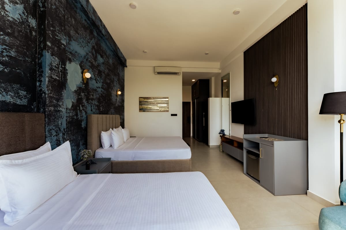 River View Room 1, double and single beds, midnight-blue wall