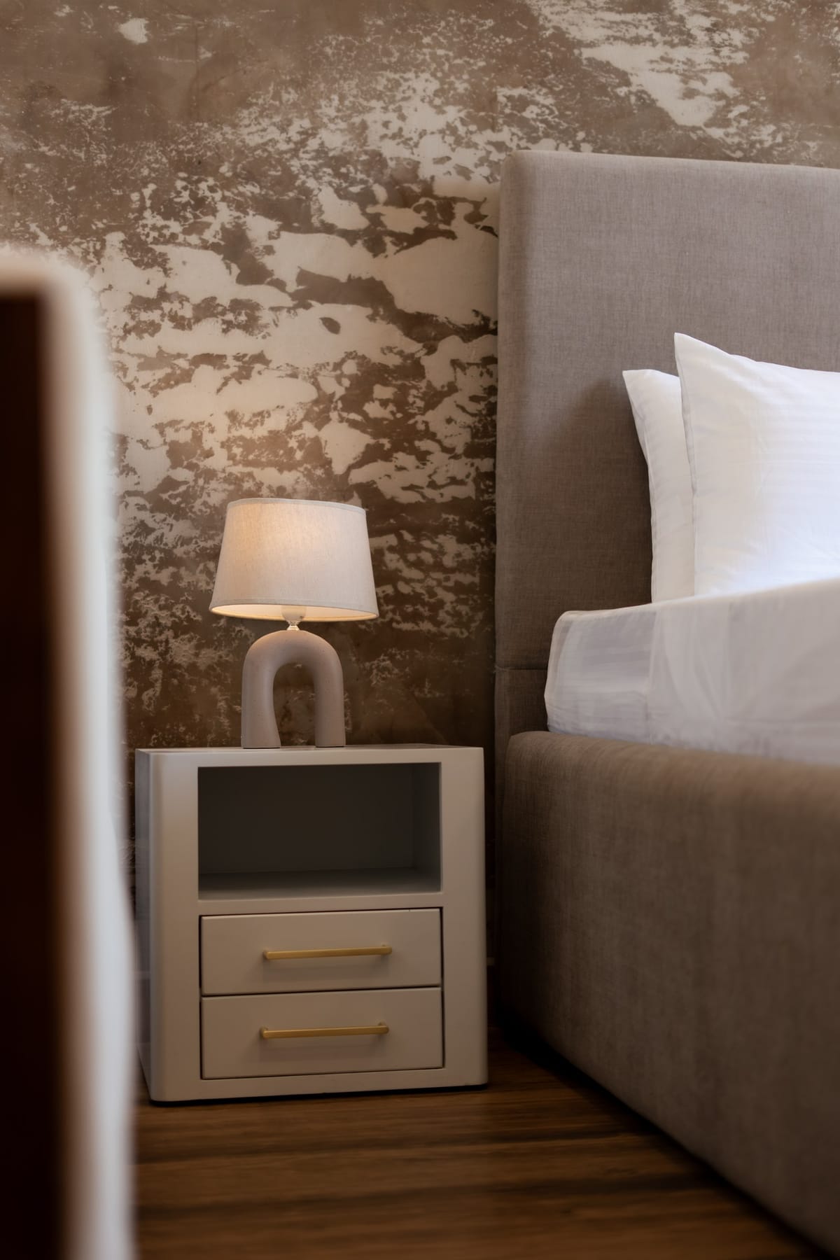 River View Room 3, bedside table and upholstered headboard